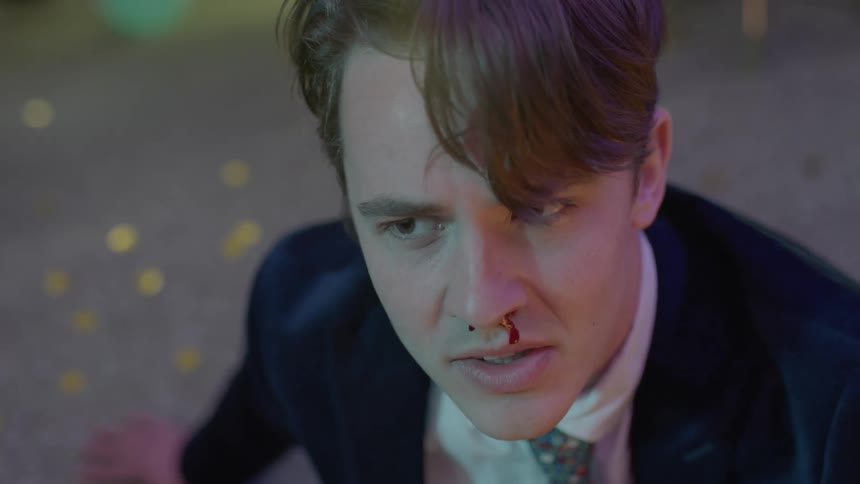 A teenage boy looking angrily and upset with blood running out of his nose