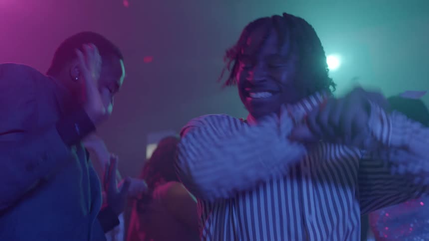 A group of people dancing and partying together