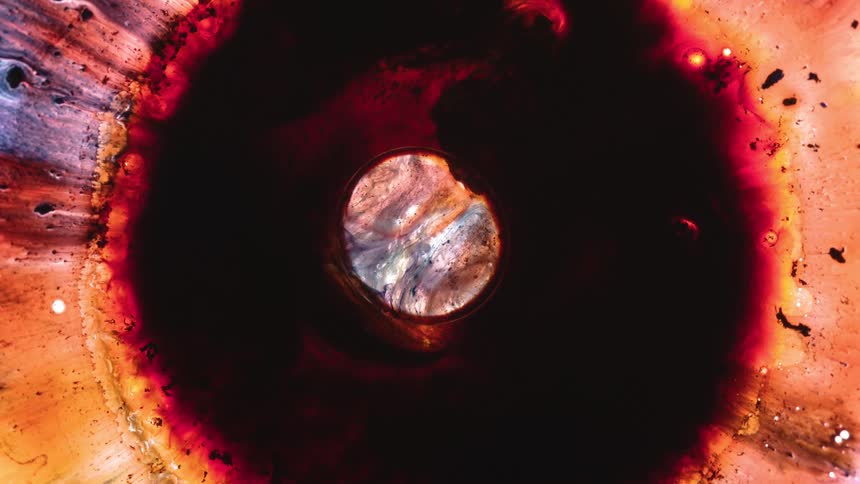 Swirling black and orange liquid