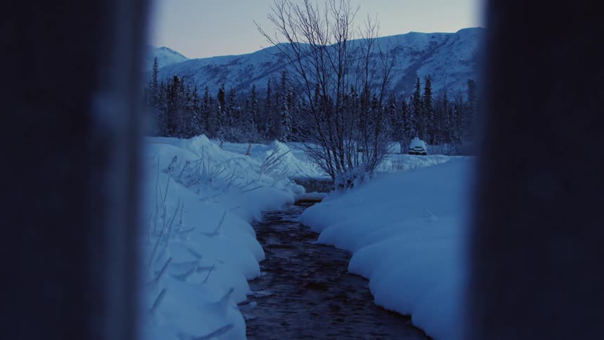 A walkway is shoveled leading to a mountain range