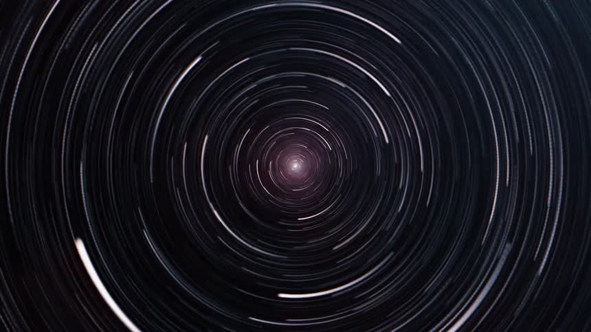 Stars in space are turning and spinning into a tunnel vortex with one bright star at the end at the tunnel as it all turns red