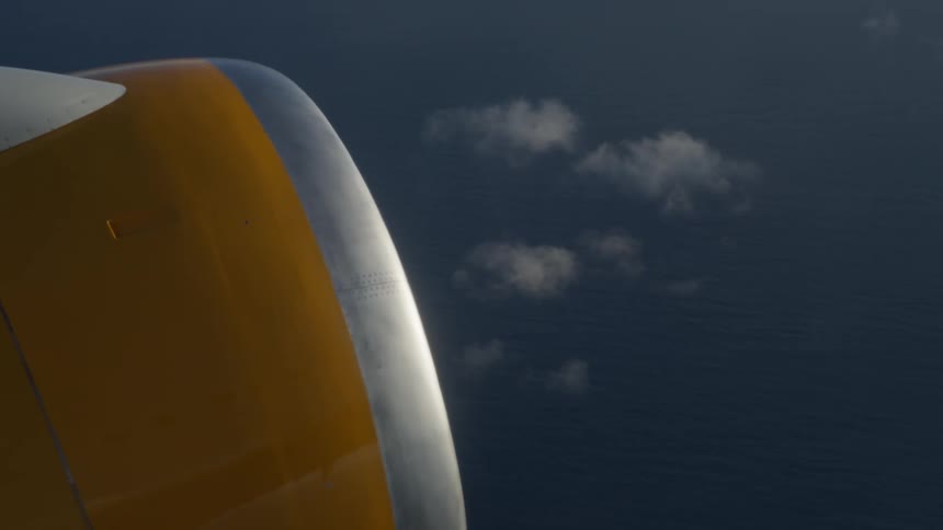 A plane flying over an ocean