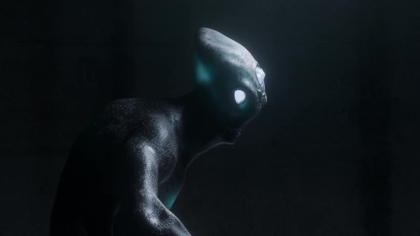 Alien being with glowing eyes stands in dark room
