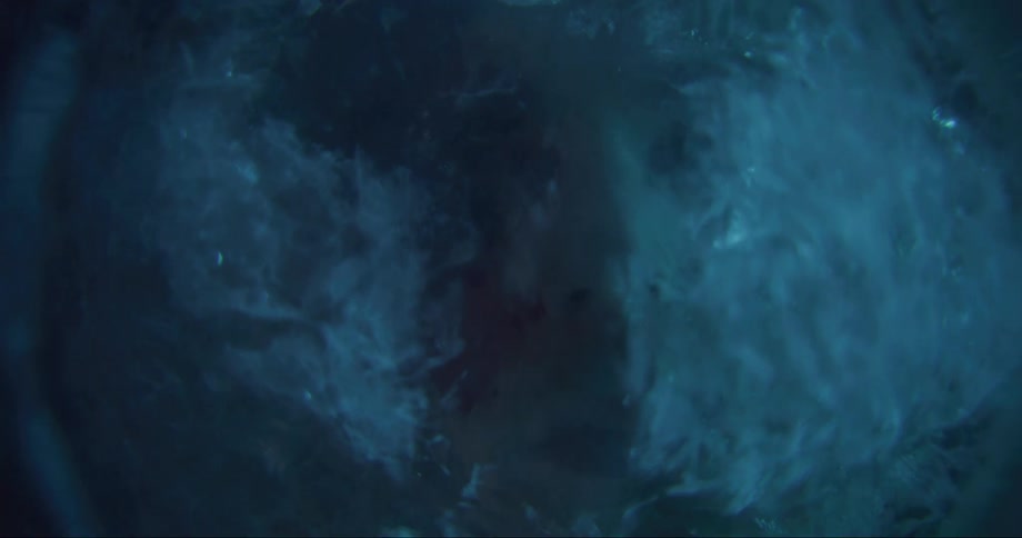 A persons face being submerged in icy water