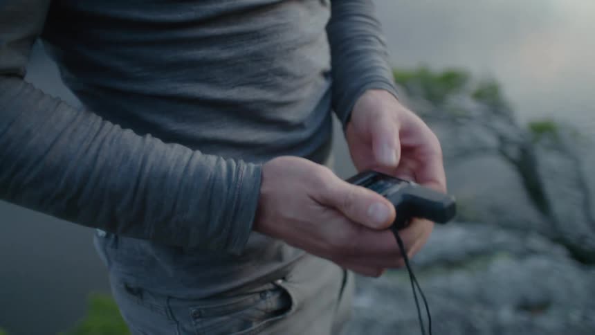 A man removes a device from his pocket