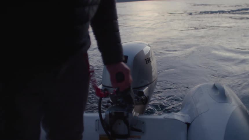 A man is steering a boat