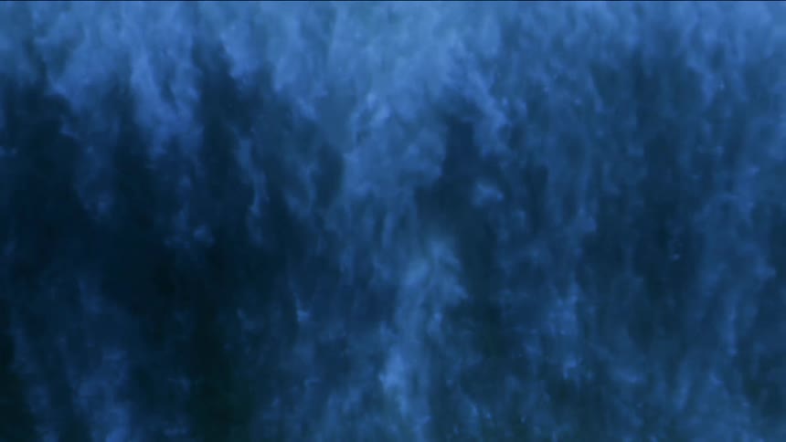Waves of blue smoke flowing down into darkness