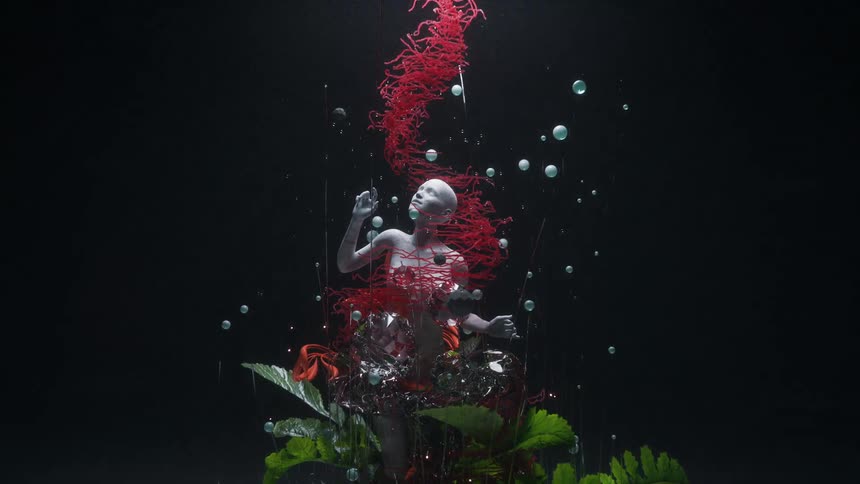 A sculpture of a human being in abstract art and plants