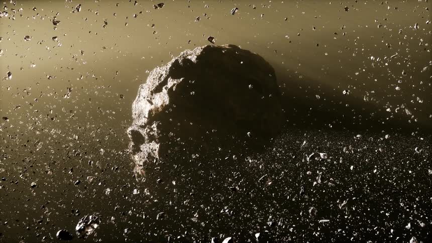 A rough planet is tumbling through space surrounded by asteroids caught in the same gravitational pull