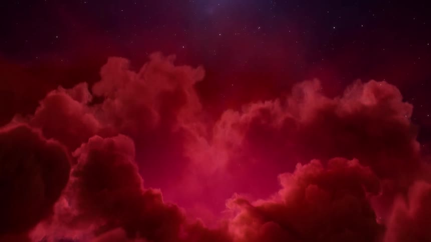 A deep red light illuminates the clouds below the stars in the darkness of space