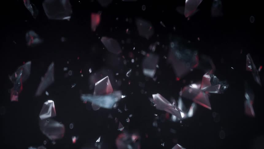 Special effects shot of a crystal formation floating against a dark background breaking up