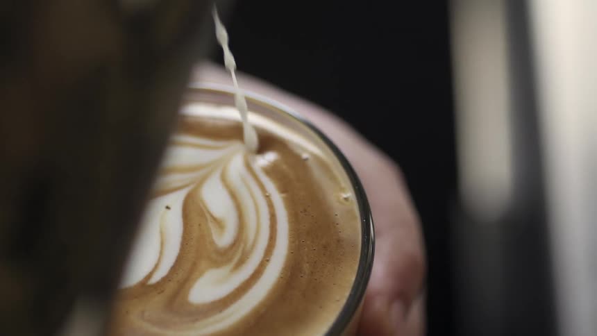 Cream is being poured into a glass