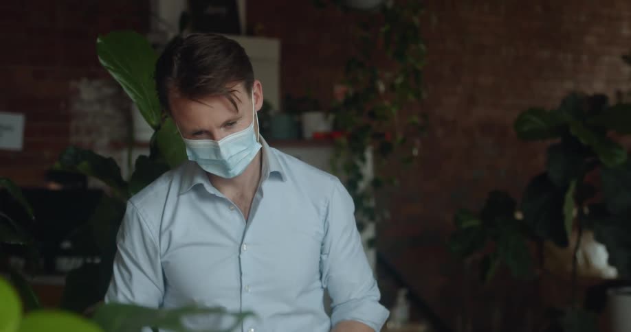 A man in an office looks through paperwork