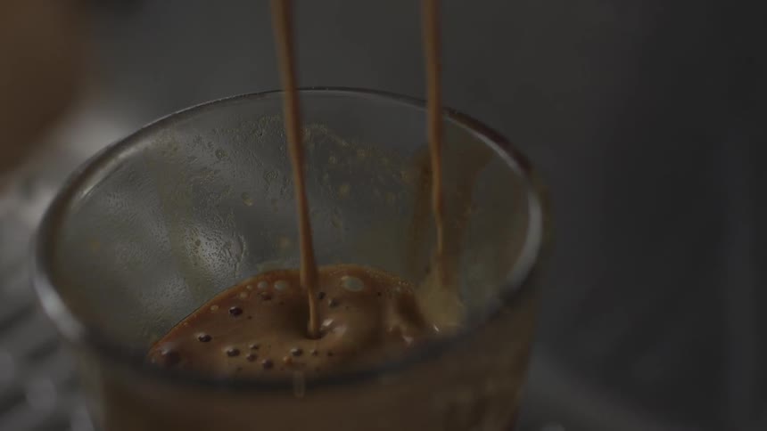 Liquid pours into a small cup