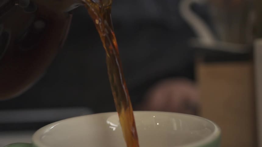 Coffee is poured into a mug