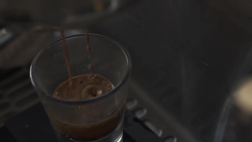 Espresso dripping into a glass