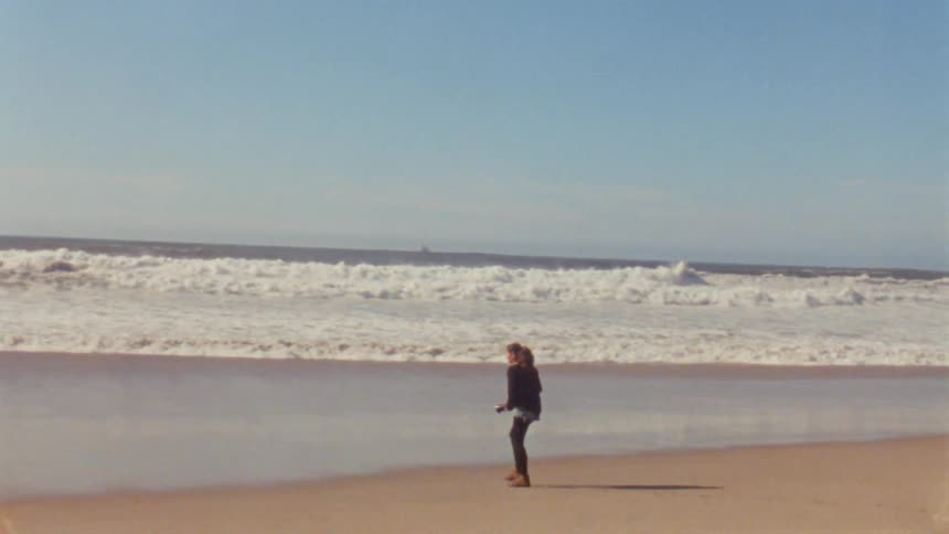 A woman taking photos of the beach