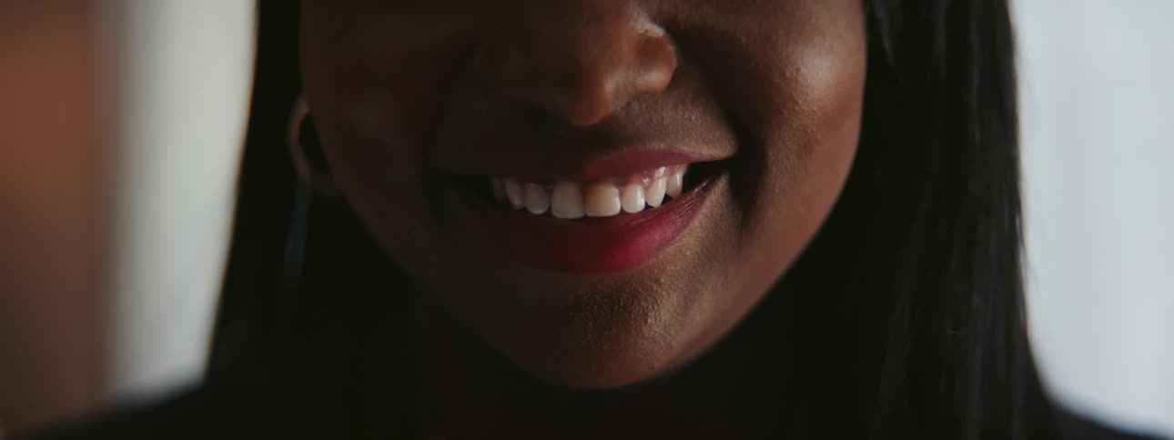 Close up of a womans mouth as she laughs and smiles