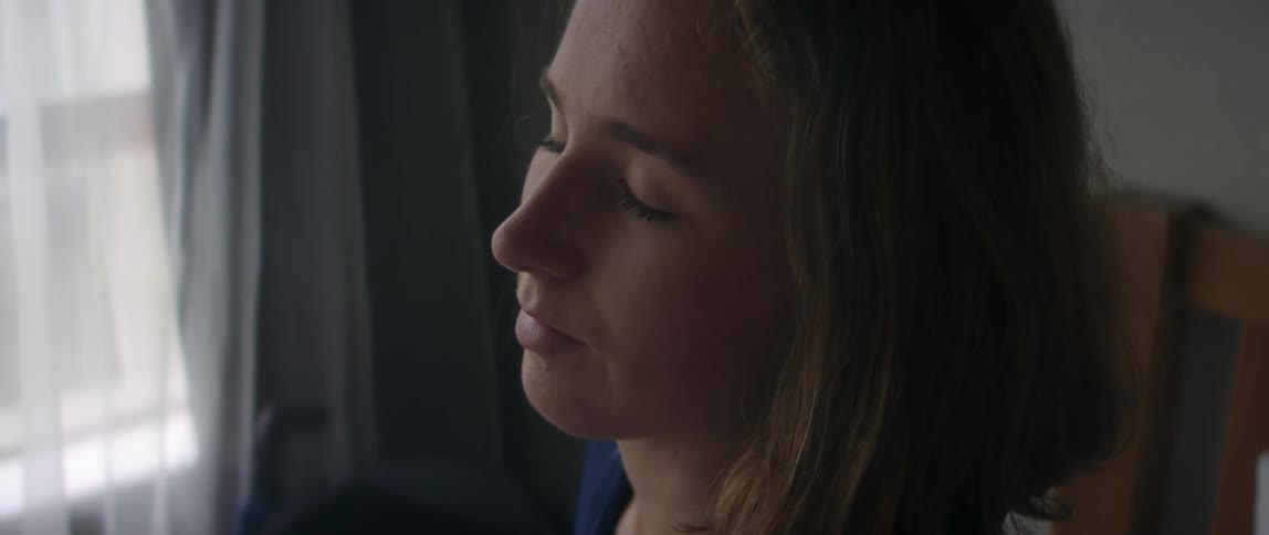 A portrait of a woman standing in a room