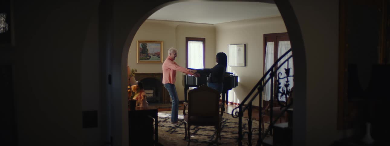 Two women dance in the living room