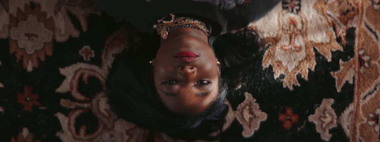 A women laying down on a rug looking up