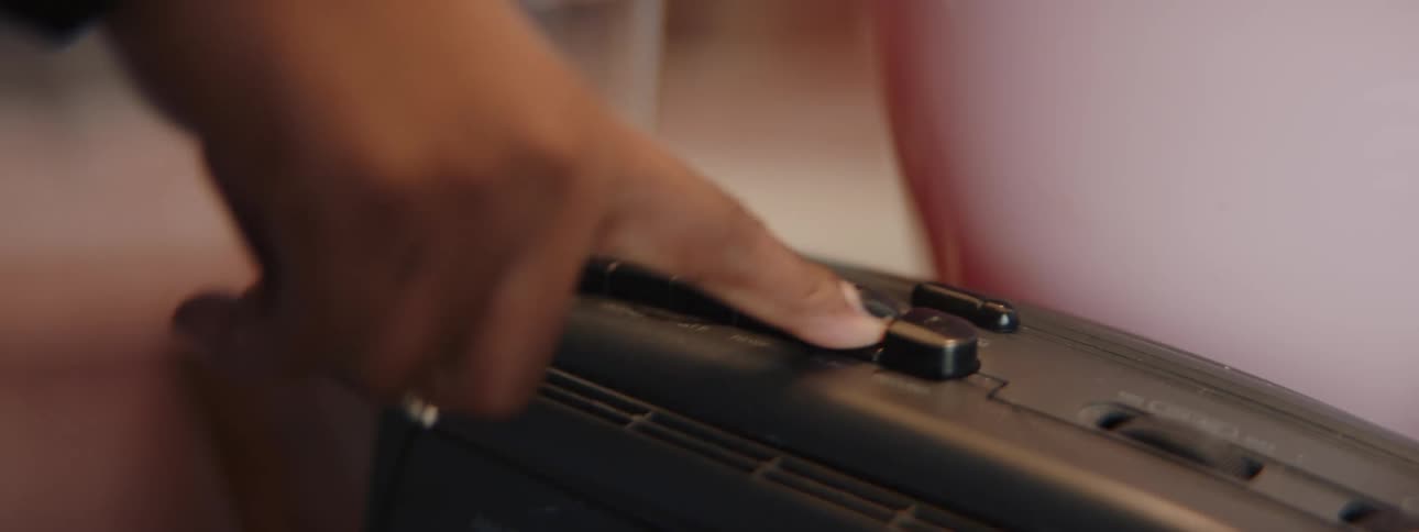 A person presses the button on the radio