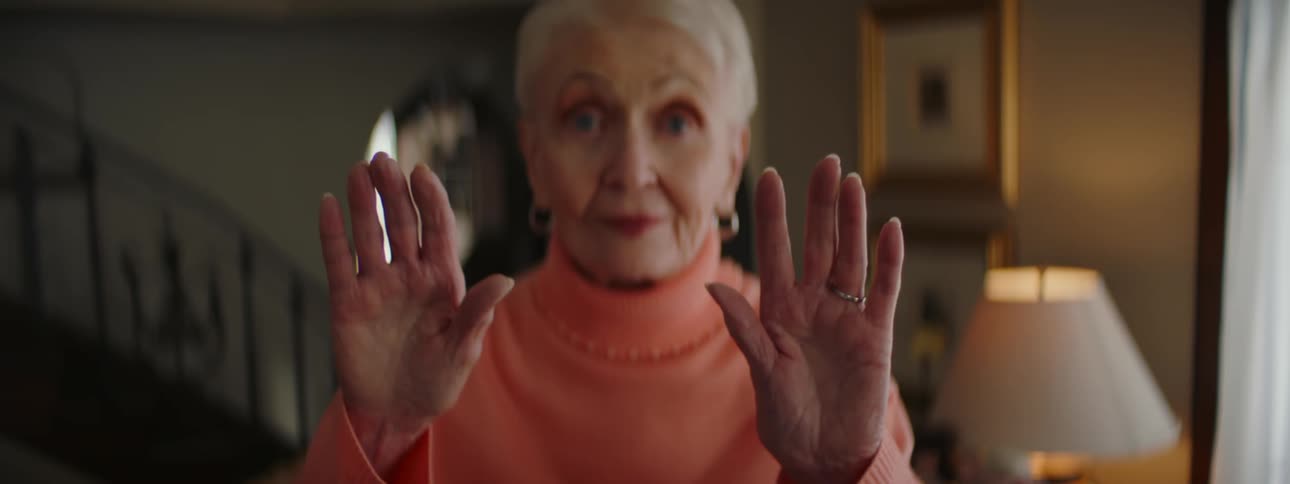 A woman moving her hands around in a room