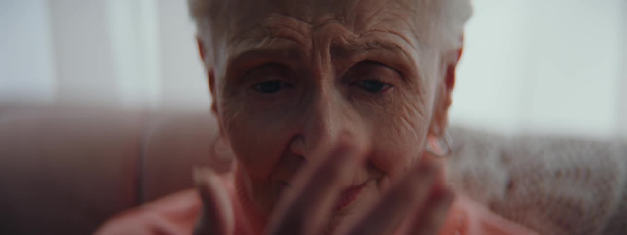 A woman is examining her hand