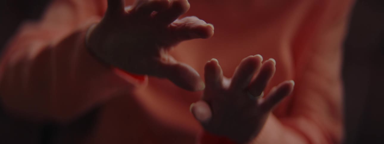 An elderly woman examining her outstretched hands