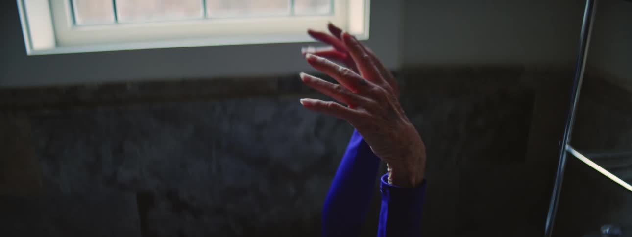 A woman is stretching her arms in the bathtub