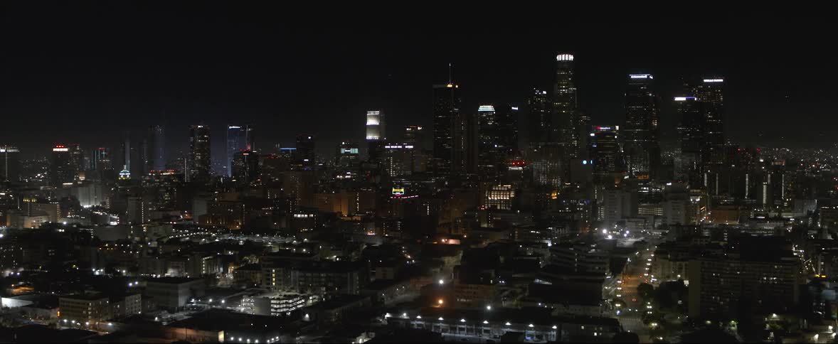 Skyscrapers and buildings are lit up in a city at night