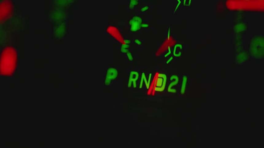 A needle on a gauge on a vehicle dashboard moves