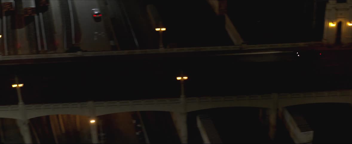 Two cars travel over the overpass