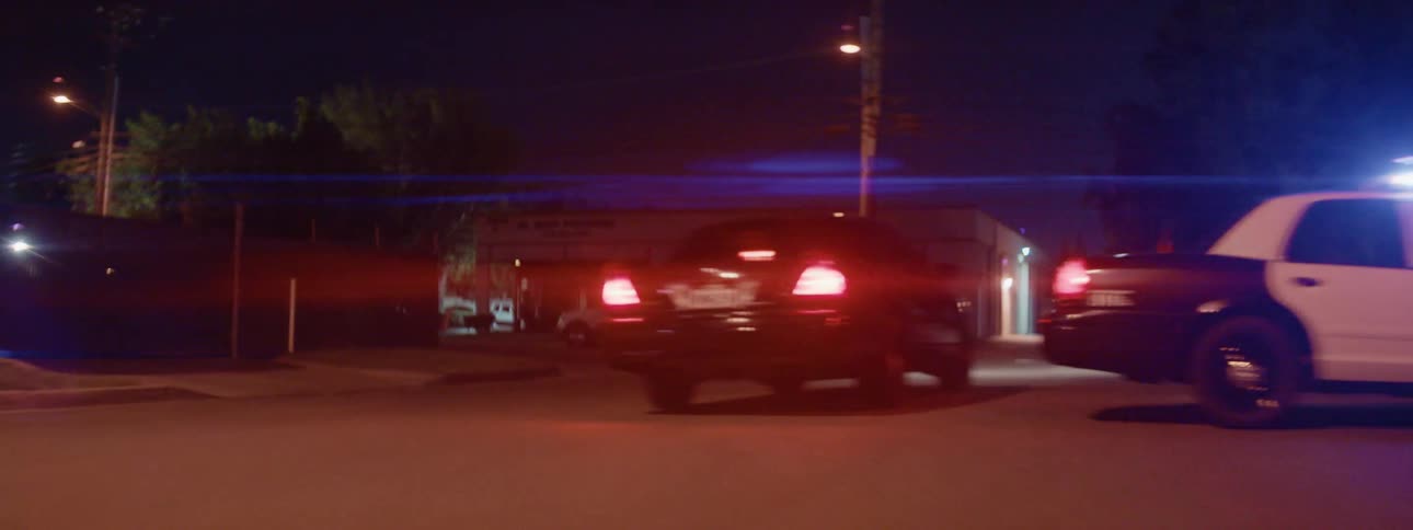 Black car escapes police blockade at night