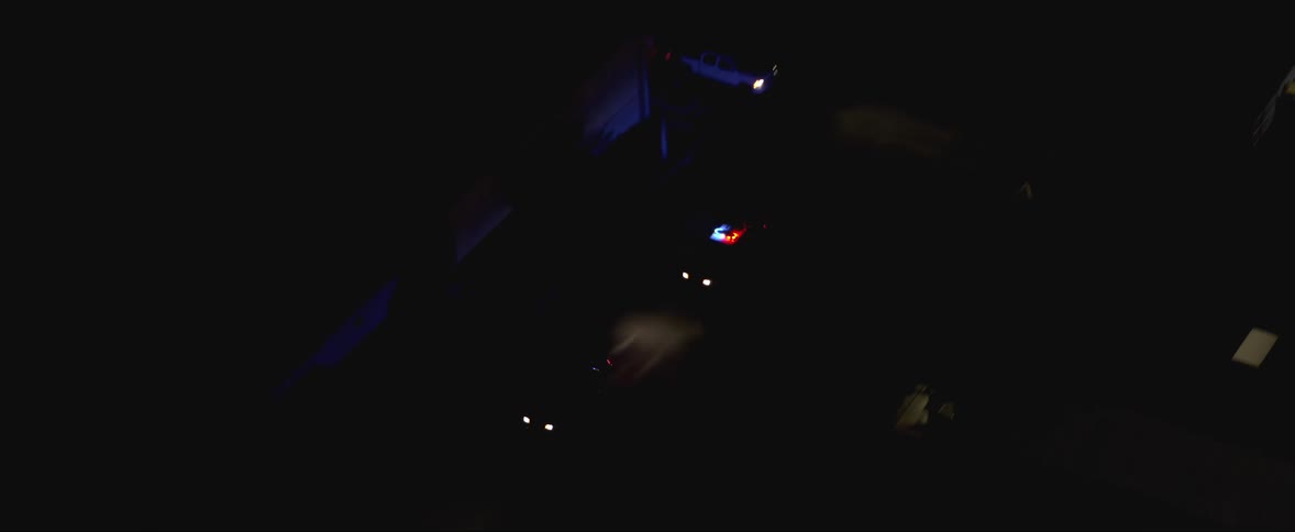 A police car is chasing a car down the street