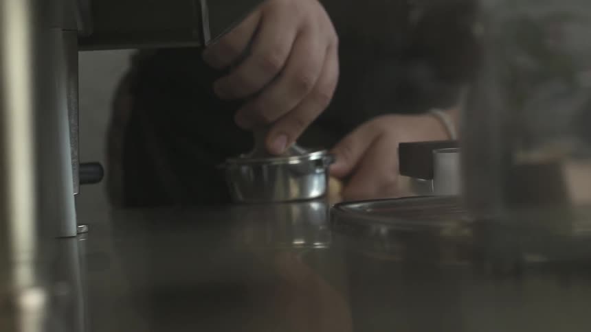 A person is pressing something in a container