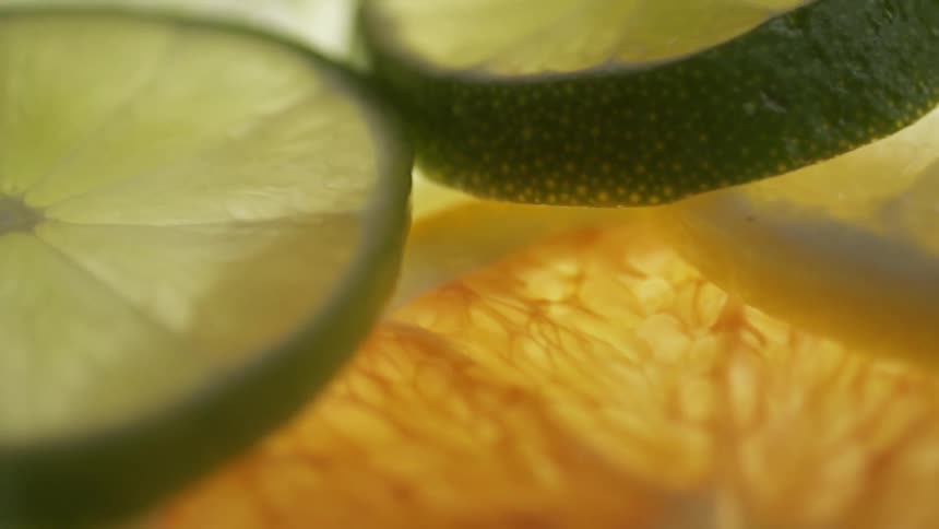 Lines and oranges are cut in a pile