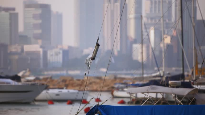 A flag blows in the wind on a boat in Hong Kong Harbor