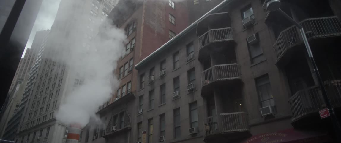 Steam rises on a city street