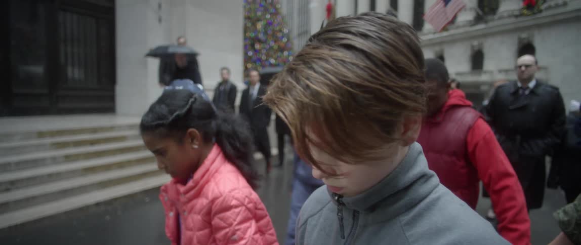 People hold hands walking slowly forward in a city