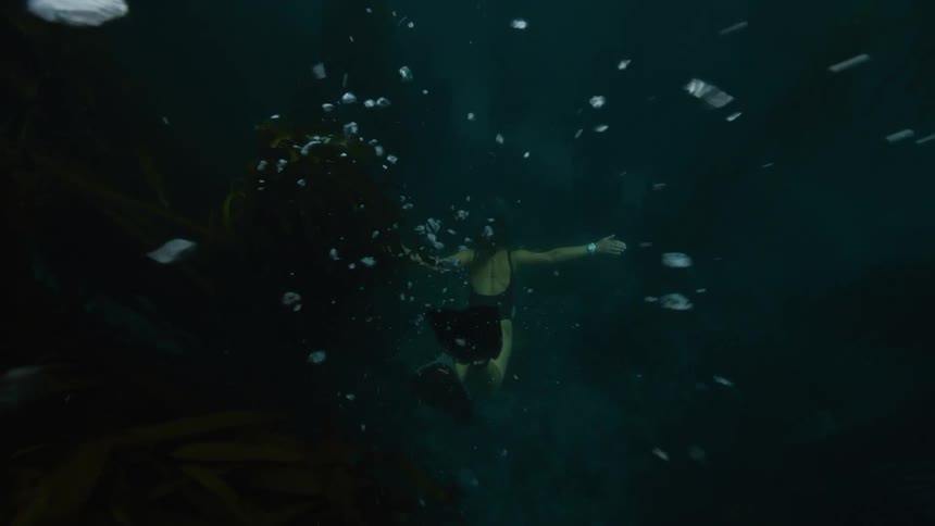 A woman is diving in the ocean water