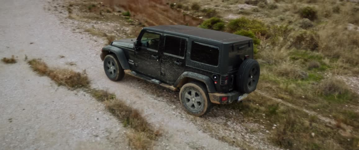 Sport utility vehicles drives on a path on a deserted area