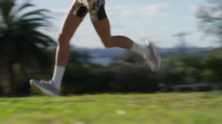 A women running on a sidewalk in midday