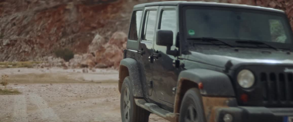 The jeep drives by the mountain