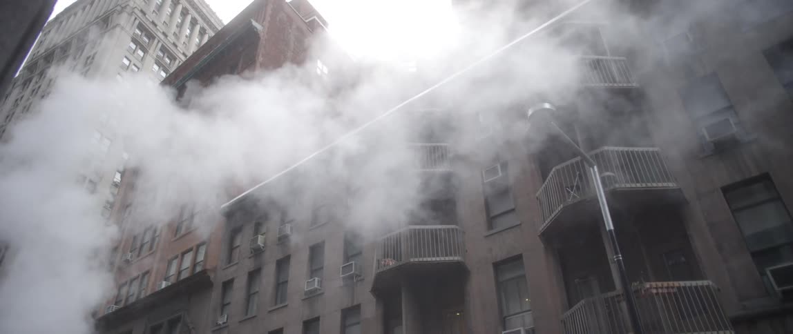 Smoke billowing near a building
