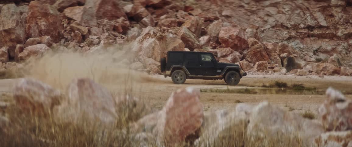 A jeep is driving in circles near the canyon