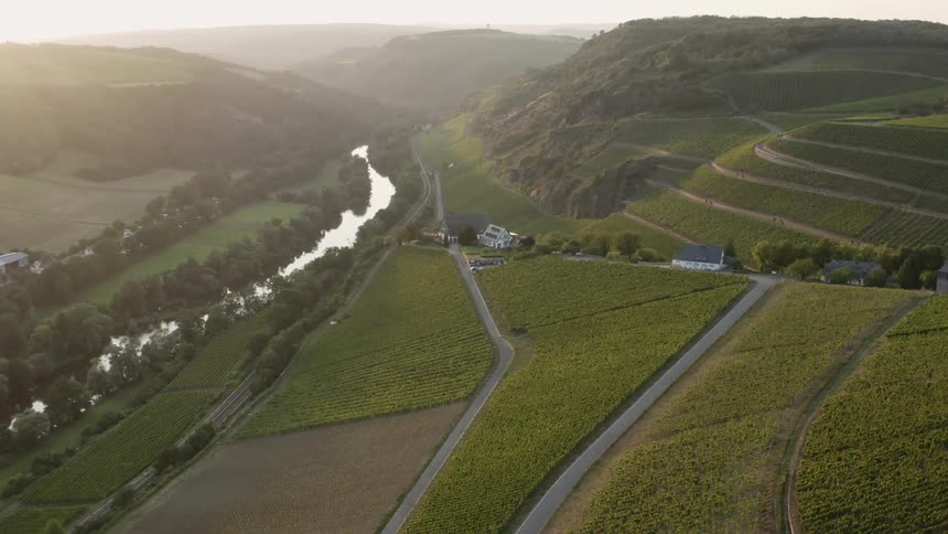 Aerial of agricultural land alongside a river in the country