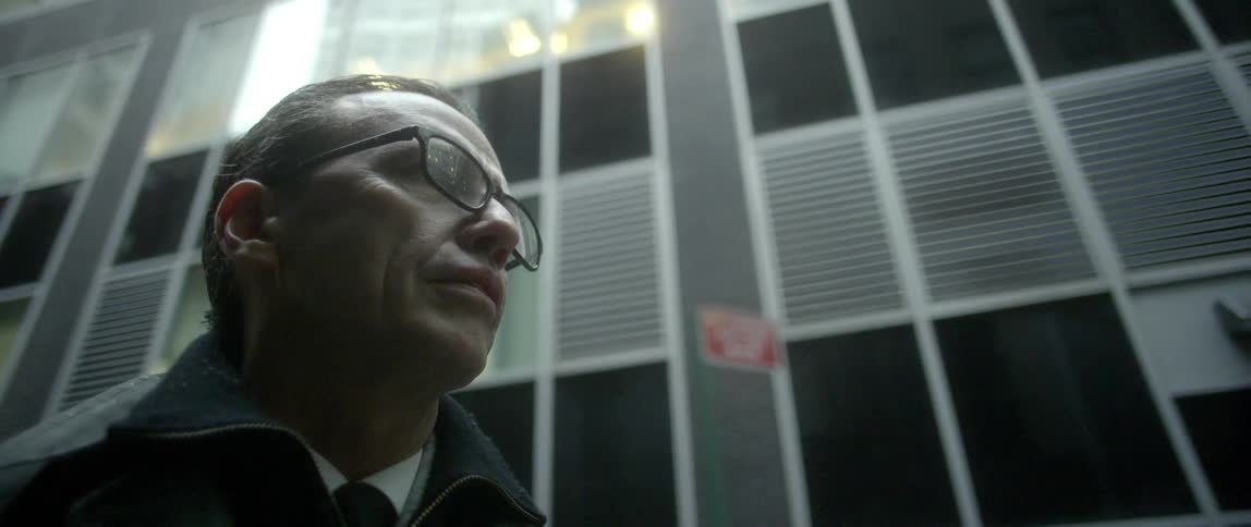 A man is standing outside in the rain