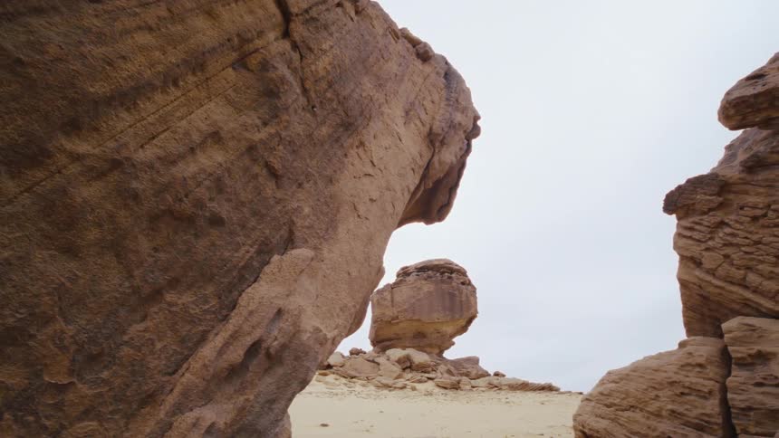View of stone formations in a desert on a cloudy day in Saudi Arabia