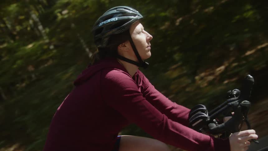 A woman rides her bicycle down the street